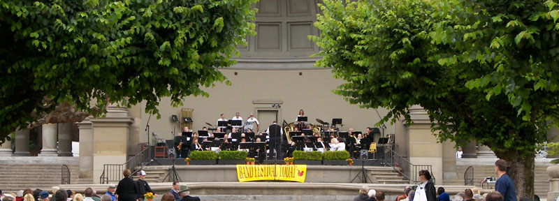 Band playing Golden Gate Park Band Shell with sign reading "Band Festival Today".